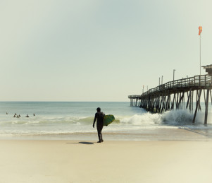 Surfers off of Avalon Fishing Pier in Outer Banks North Carolina